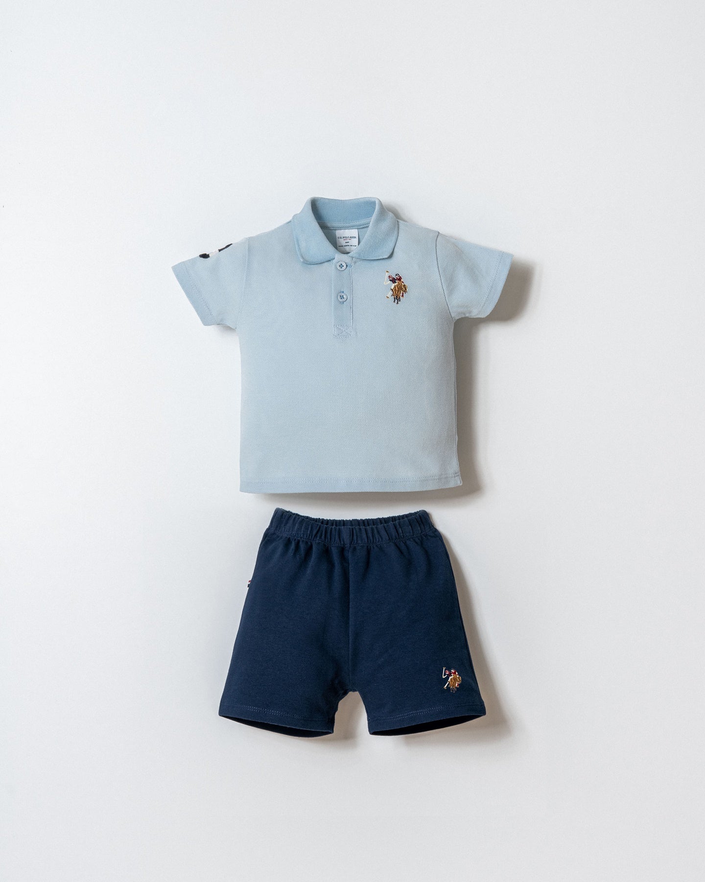 Set 2 Piese Băiețel Tricou Polo Albastru Deschis Și Pantaloni Scurți Bleumarin Cu Logo Colorat